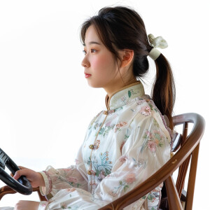 A cute asian woman sitting in a wooden chair
Brown ponytail
O...