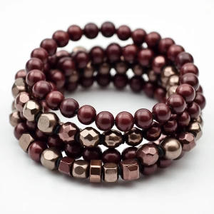 "A multi-strand bracelet combining burgundy beads with metallic...