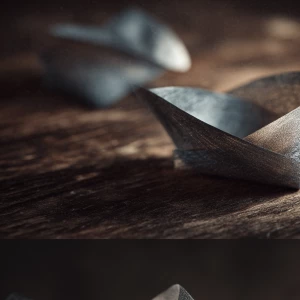 A minimalist Japanese zen composition with soft silver foil gent...
