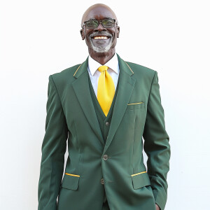 A man wearing a suit.

The Suit Color is Green

The Tie Color is...