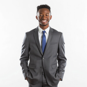 A man wearing a suit.

The Suit Color is gray 

The Tie Color is...