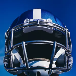 Captured at eye-level on a vibrant day, a close-up of a football...
