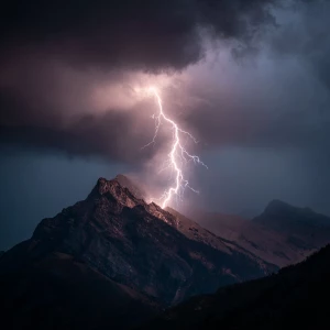 A dramatic lightning strike on a rugged mountain during a stormy...