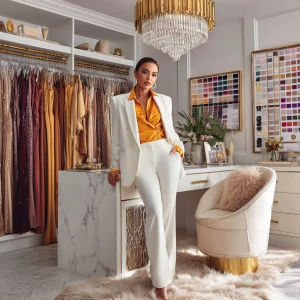 A confident female stylist, radiating power, poses in her luxuri...