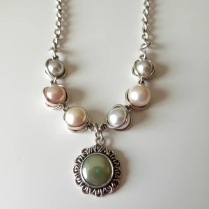 Design an avant-garde necklace with asymmetrical freshwater pear...