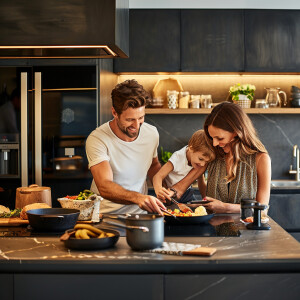 A happy family cooking and spending time in a beautiful luxuriou...