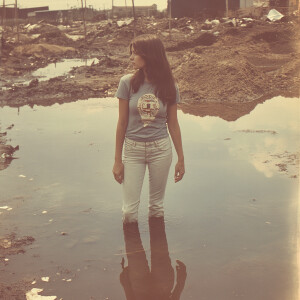 Faded film photograph from 1972 of a gorgeous, 26-year-old, brun...