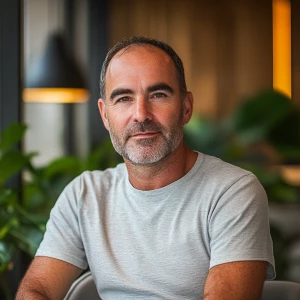 This photograph depicts a middle-aged man with a receding hairli...