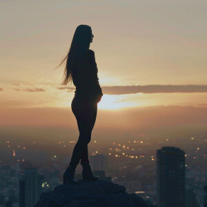 Fair-skinned woman with dark long hair, elegant and composed, st...