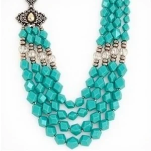 A multi-strand statement necklace featuring graduated layers of...