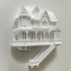 3D printed scale model of a house being displayed as art on a wall