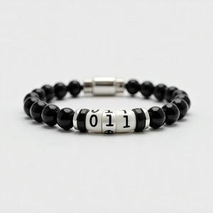 A minimalist, tech-inspired bracelet featuring a binary code pat...