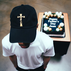 Imagine a 26-year-old man standing in front of a cake, adorned w...