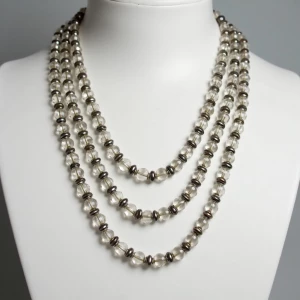 "A long opera-length necklace featuring alternating clear crysta...