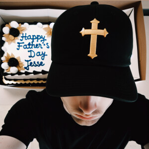 Imagine a 26-year-old man standing in front of a cake, adorned w...