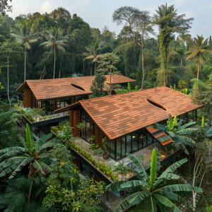Top distantly viewed pictures of two Kerala sloping roof with on...
