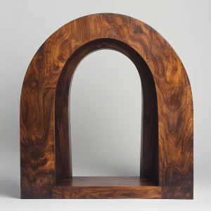 A wooden archway, centered in the image. The arch is carved from a single piece of dark brown wood, exhibiting natural wood grain patterns and variations in tone.  The archway has a smooth, semi-circular shape and appears to be part of a larger wooden structure.  The wood has a rich, dark brown color with lighter, streaky highlights.  The interior of the archway is completely black. The archway sits atop a horizontal wooden base or lintel, which matches the color and grain of the arch. The framing of the archway, with its pillars and base, provides a sense of depth and structure. The background is a plain, light gray or white wall. The overall style is rustic, minimalist, and natural, evoking a sense of warmth and organic beauty. The lighting is even, casting no distinct shadows within the image, which enhances the focus on the wood texture and its details. The perspective is straight-on, looking directly at the archway.