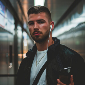 Create a portrait of a young man in a modern urban setting. He h...