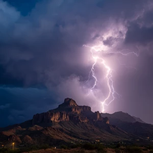 A dramatic lightning strike on a rugged mountain during a stormy...
