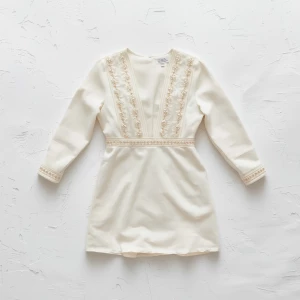 Create a minimalist flat lay composition with allover embellishe...