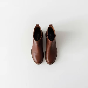 Create a minimalist flat lay composition with a pair of  brown b...