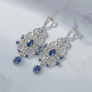Design elegant chandelier earrings gleaming with intricate silve...