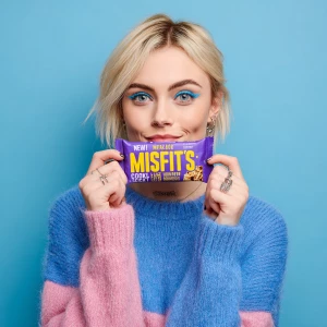 This image features a young woman holding a "MISFITS Cookie Doug...