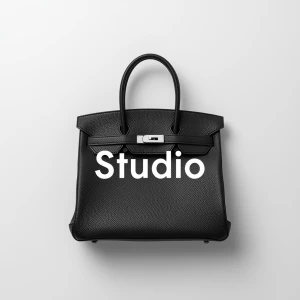 Create a minimalist flat lay composition with a black structured...