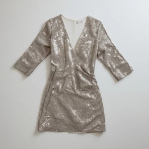 Create a minimalist flat lay composition with a couture sequin d...
