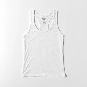 Produce an elegant flat lay image featuring a basic white tank t...