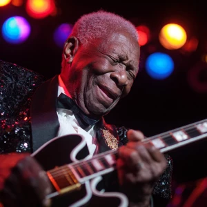 Intimate close-up of B.B. King’s upper body, wearing a black seq...