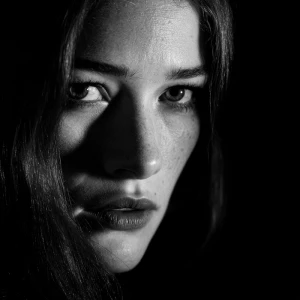 Create an intense close-up portrait of a woman surrounded by dee...