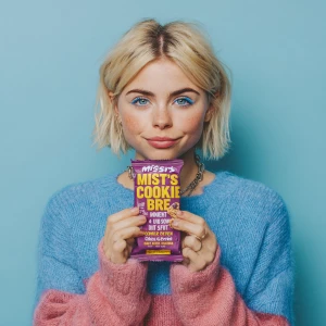 This image features a young woman holding a "MISFITS Cookie Doug...