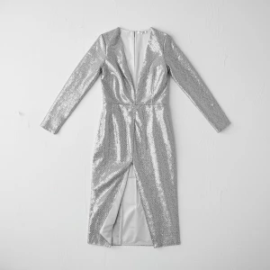 Create a minimalist flat lay composition with a couture silver s...