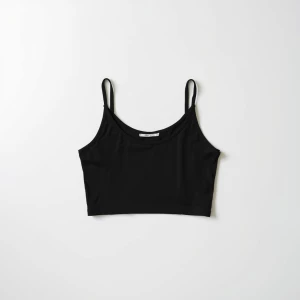 Produce an elegant flat lay image featuring a basic black crop t...