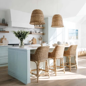 Create a serene coastal kitchen scene featuring rattan bar stool...