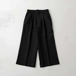 Create a minimalist flat lay composition with a classic Black wi...