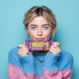 This image features a young woman holding a "MISFITS Cookie Doug...