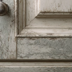 one kitchen cabinet door with slightly worn paint near the handl...