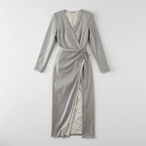 Create a minimalist flat lay composition with a couture silver s...