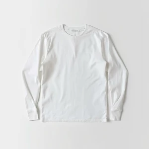 Produce an elegant flat lay image featuring a basic white longsl...