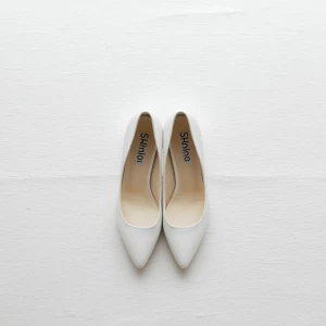 Create a minimalist flat lay composition with a pair of classic...