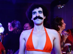 A girl wearing the Borat mankini to a party.