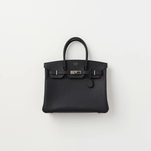 Create a minimalist flat lay composition with a black structured...