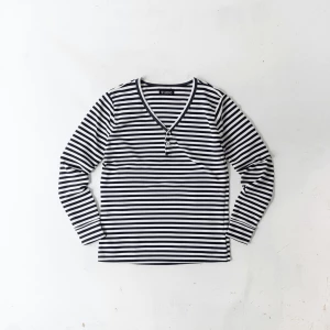 Create a minimalist flat lay composition with a striped longslee...