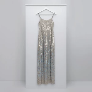 A dazzling sequin dress hanging elegantly on a sleek, minimalist...