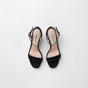 Create a minimalist flat lay composition with a pair of  black h...