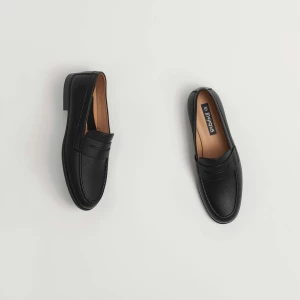 Create a minimalist flat lay composition with a pair of  black l...