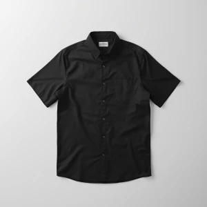 Produce an elegant flat lay image featuring a basic black shirt...